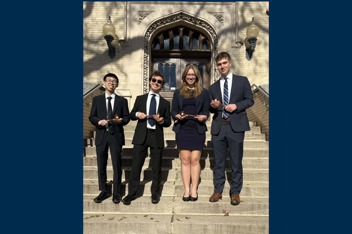 four students standing on steps